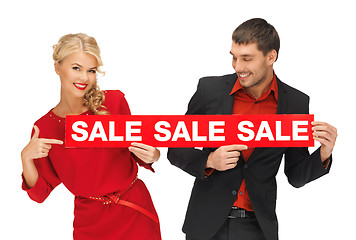 Image showing man and woman with sale sign