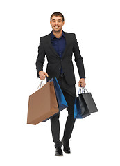 Image showing handsome man in suit with shopping bags