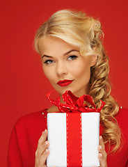 Image showing lovely woman in red dress with present