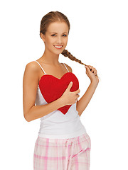 Image showing happy and smiling woman with heart-shaped pillow