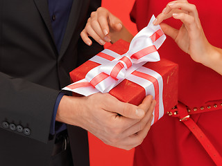 Image showing man and woman's hands with gift box