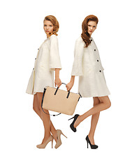 Image showing two teenage girls in white coats with bag