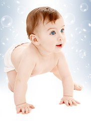 Image showing crawling baby boy looking up