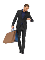 Image showing handsome man in suit with shopping bags