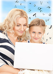 Image showing happy mother and child with laptop computer