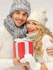 Image showing romantic couple in a sweaters with gift box