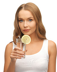 Image showing woman with lemon slice on glass of water