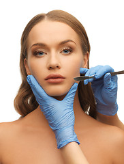 Image showing woman face and beautician hands