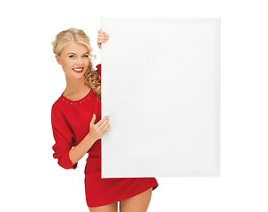 Image showing lovely woman in red dress with blank board