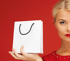 Image showing lovely woman in red dress with shopping bag