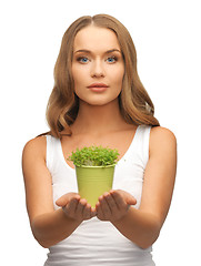 Image showing woman with green grass in pot