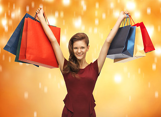 Image showing teenage girl in red dress with shopping bags