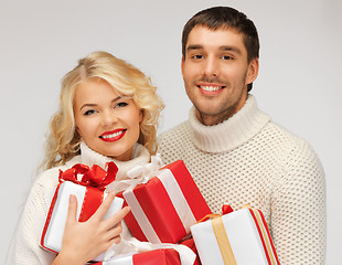 Image showing family couple in a sweaters with gift boxes