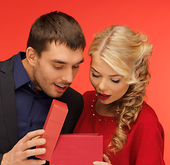 Image showing man and woman looking inside the gift box