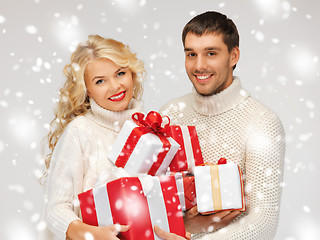 Image showing family couple in a sweaters with gift boxes