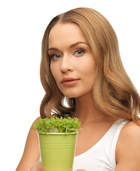 Image showing woman with green grass in pot