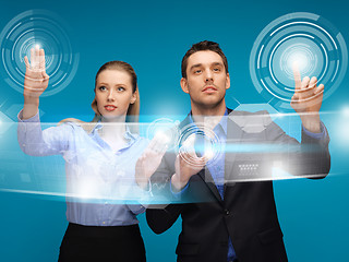 Image showing man and woman working with virtual touch screens