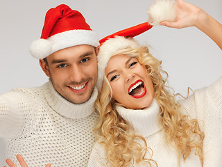 Image showing family couple in sweaters and santa's hats