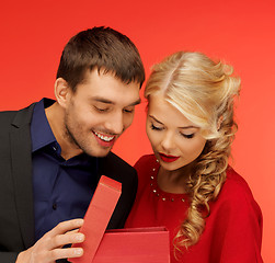 Image showing man and woman looking inside the gift box