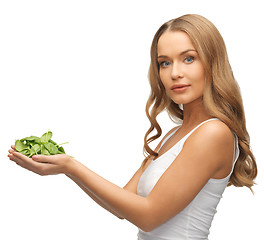 Image showing woman with spinach leaves on palms