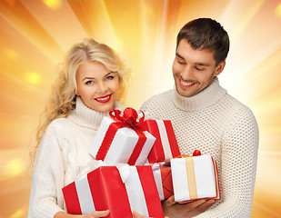 Image showing family couple in a sweaters with gift boxes