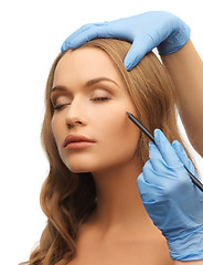 Image showing woman face and beautician hands