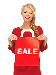 Image showing beautiful woman in red dress with shopping bag