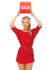 Image showing lovely woman in red dress with sale sign