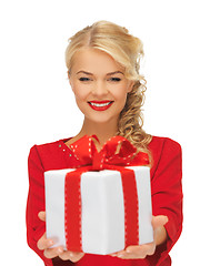 Image showing lovely woman in red dress with present