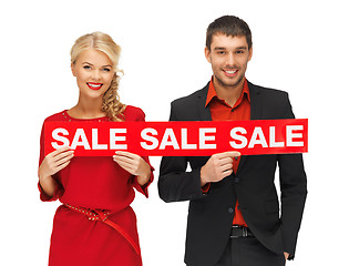 Image showing man and woman with sale sign