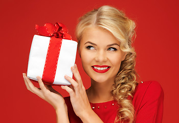 Image showing lovely woman in red dress with present