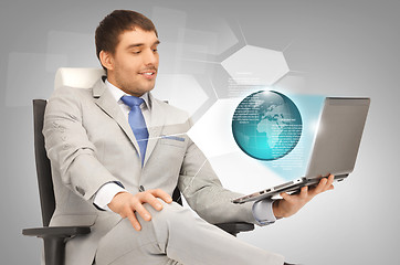 Image showing businessman with laptop and virtual screens