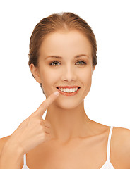 Image showing beautiful woman pointing to teeth