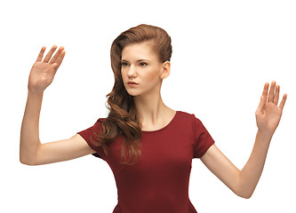 Image showing girl in red dress working with something imaginary