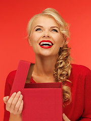 Image showing lovely woman in red dress with opened gift box