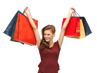 Image showing teenage girl in red dress with shopping bags