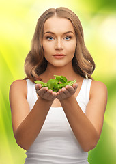 Image showing woman with spinach leaves on palms