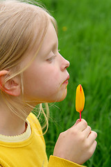 Image showing Licking yellow ice-cream