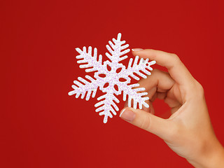 Image showing woman's hands holding a snowflake