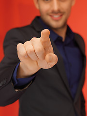 Image showing handsome man in suit pressing virtual button
