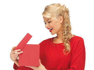 Image showing lovely woman in red dress with opened gift box