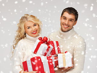 Image showing family couple in a sweaters with gift boxes