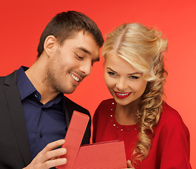 Image showing man and woman looking inside the gift box