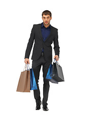 Image showing handsome man in suit with shopping bags