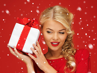 Image showing lovely woman in red dress with present