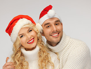 Image showing family couple in sweaters and santa's hats