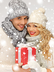 Image showing romantic couple in a sweaters with gift box