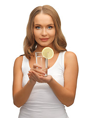 Image showing woman with lemon slice on glass of water