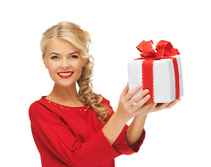 Image showing lovely woman in red dress with present