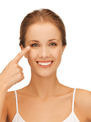 Image showing beautiful woman pointing to eye